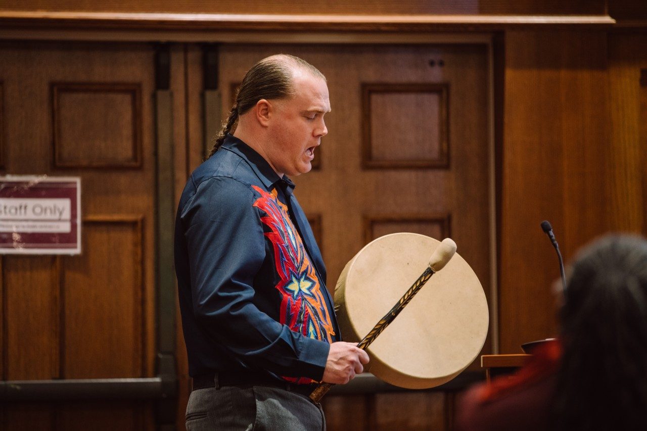 Rufus Elliot, the first member of Monacan Nation to graduate from Virginia Tech, plays a Native American drum while singing.